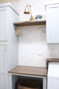 laundry room-diy-blue-cabinets-easy-marble-wall-tile-gold-sconce-light-rustic-shelves-countertop