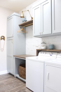 laundry room-diy-painted-blue-cabinets-marble-wall-tile-gold-sconce-light-rustic-shelf-anbove-washer-dryer