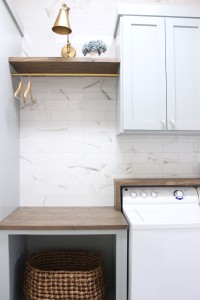 laundry room-diy-painted-cabinets-marble-wall-tile-countertop-rustic-waterfall-shelf-above-washer-dryer
